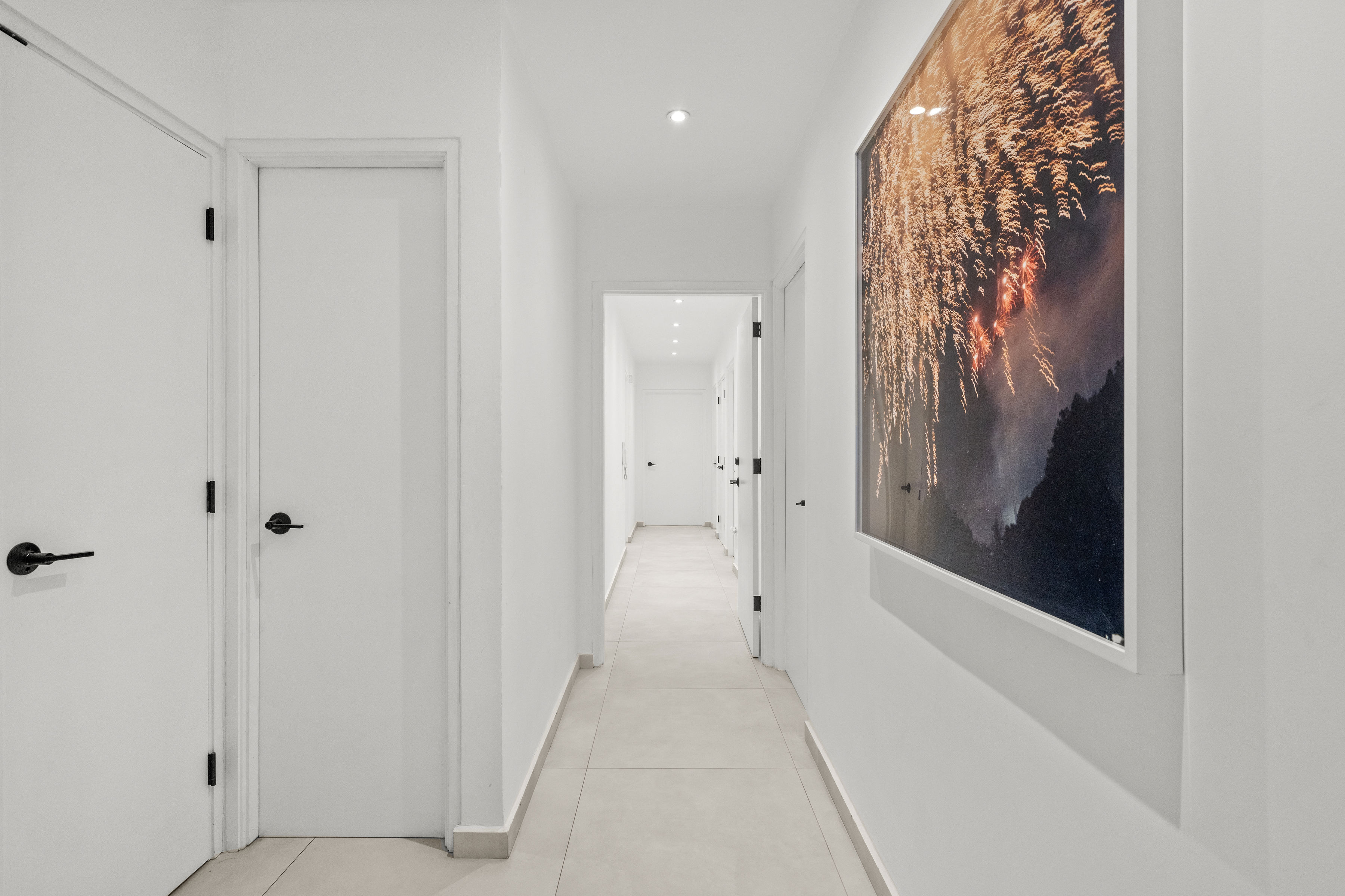 Casa Cervantes 2 | Bright interior hallway with contemporary artwork and clean architectural lines