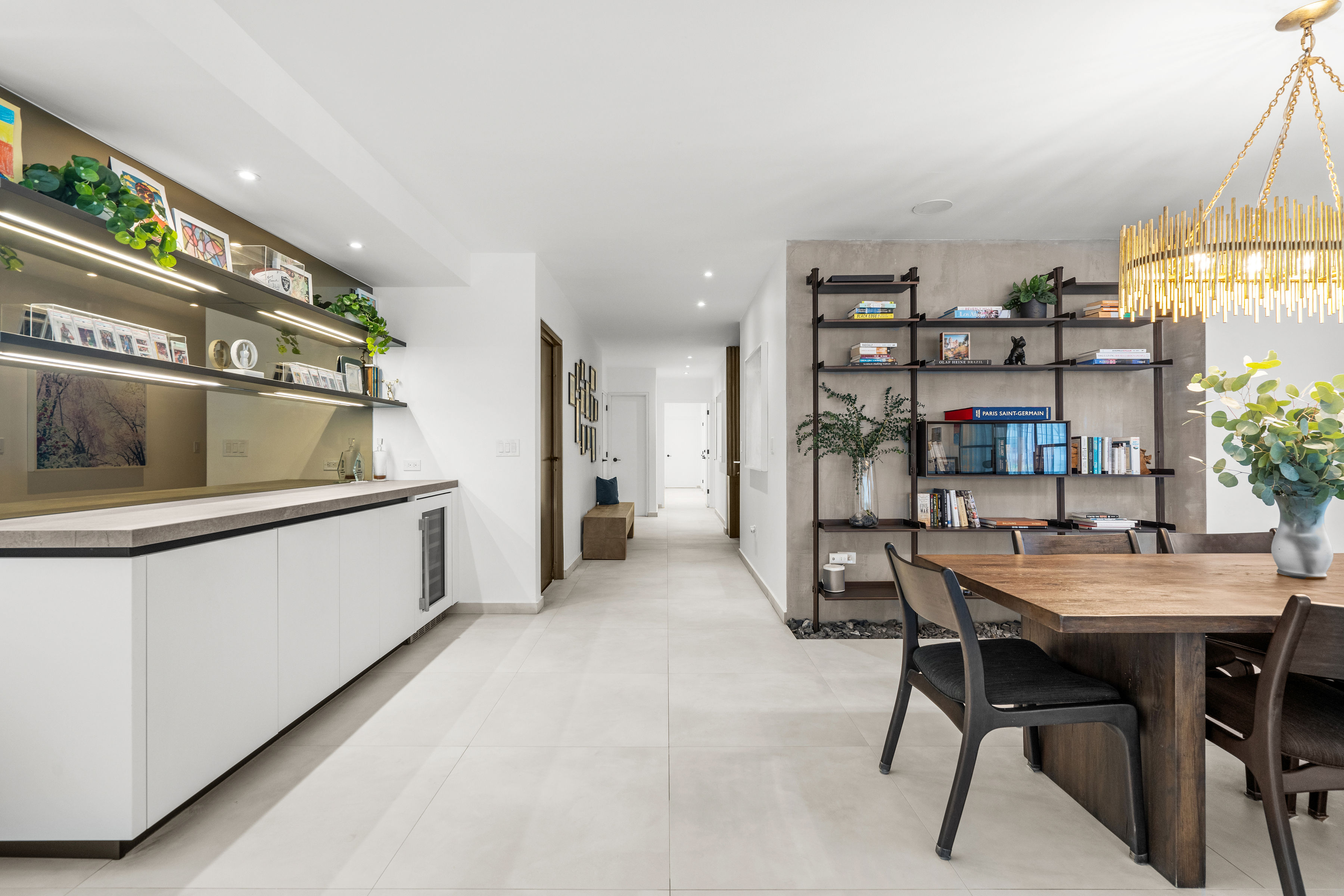 Casa Cervantes 2 | Dining area with custom built-in bar, illuminated shelving, and contemporary finishes