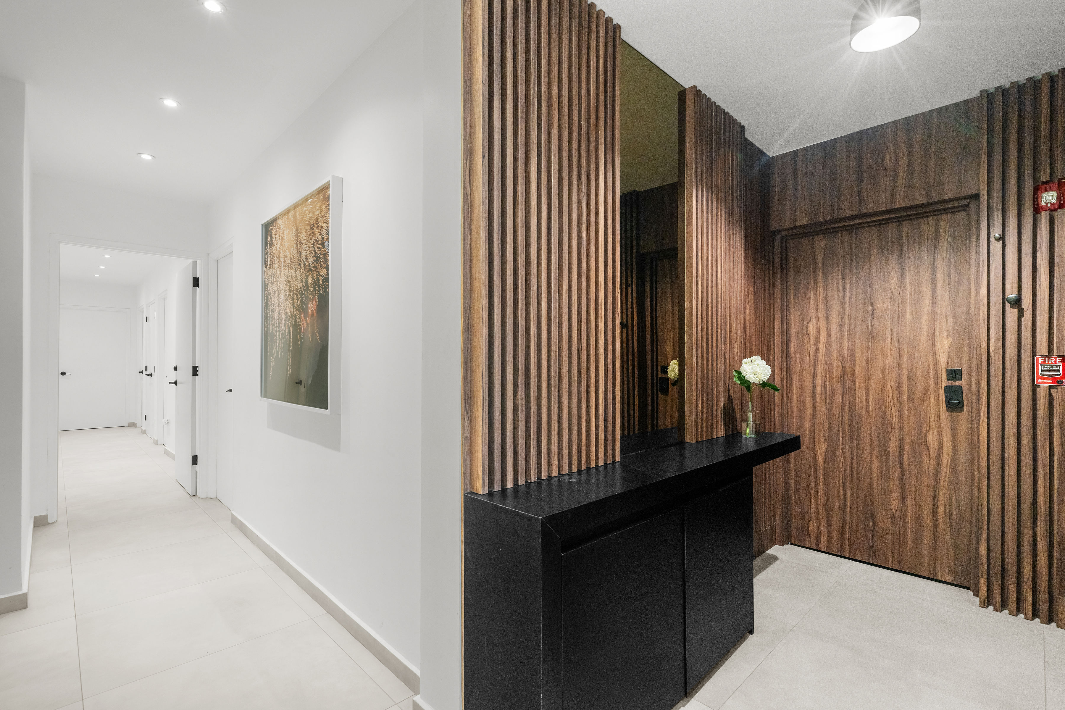 Casa Cervantes 2 | Contemporary entry foyer with custom wood paneling and built-in console