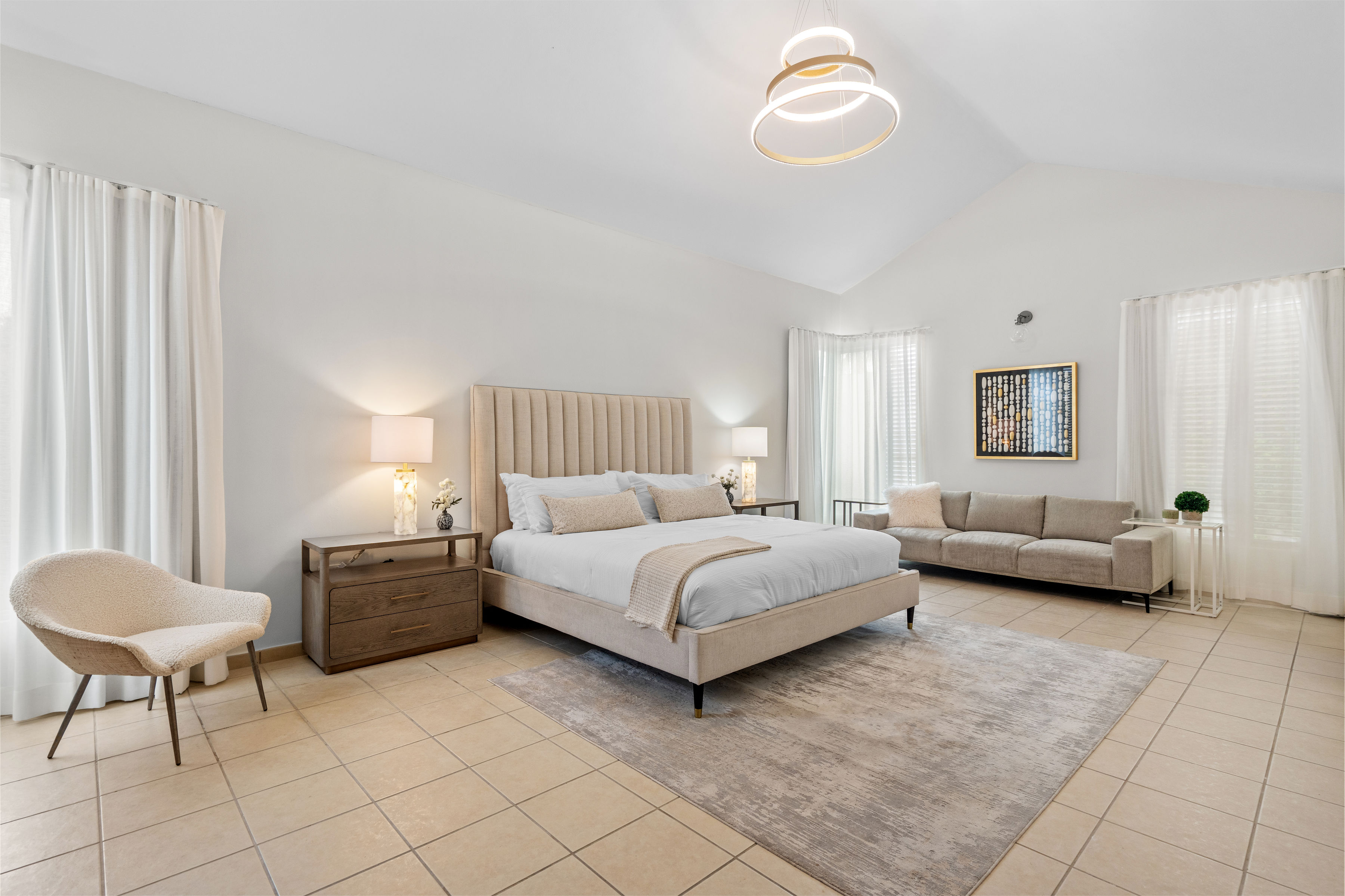 Sabanera Dorado 309 | Spacious primary bedroom with high ceilings, sitting area, and natural light