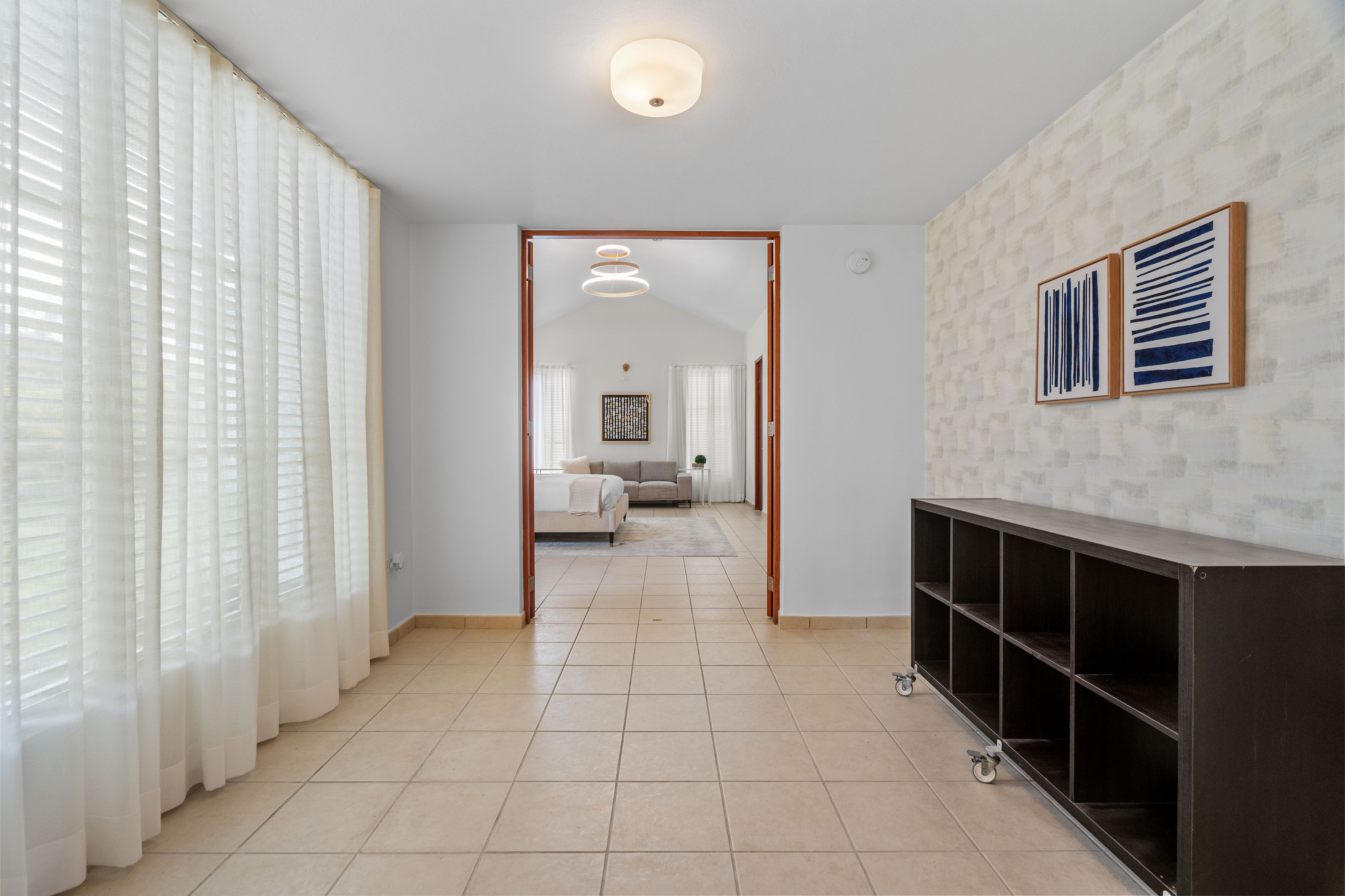 Sabanera Dorado 309 | Bright interior space with large windows leading into the primary bedroom