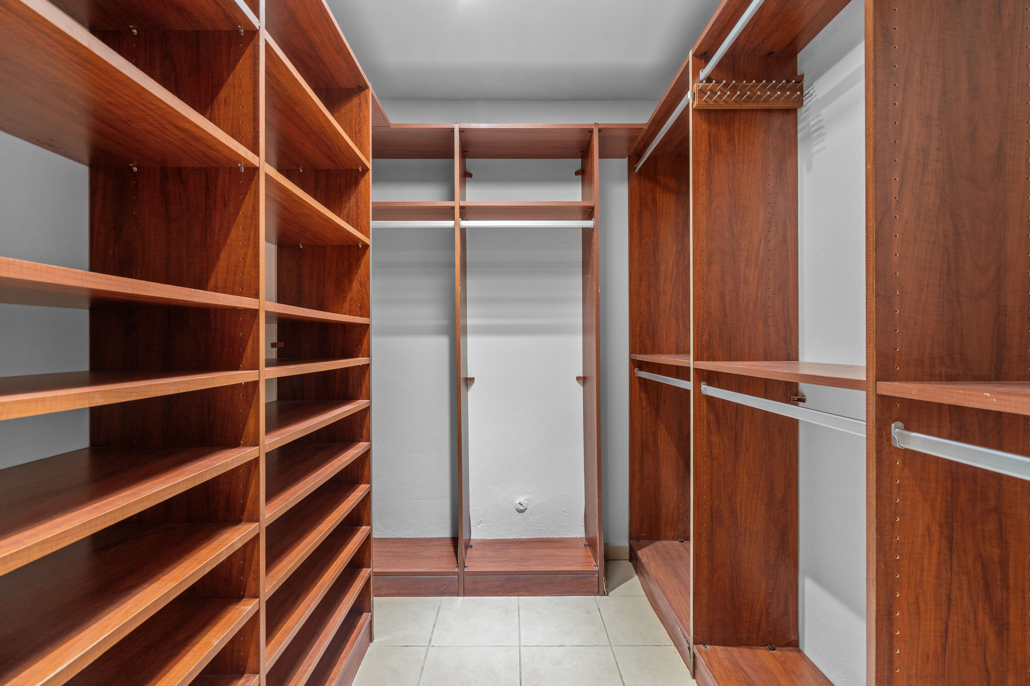 Sabanera Dorado 309 | Large walk-in closet with extensive built-in wood shelving and hanging storage
