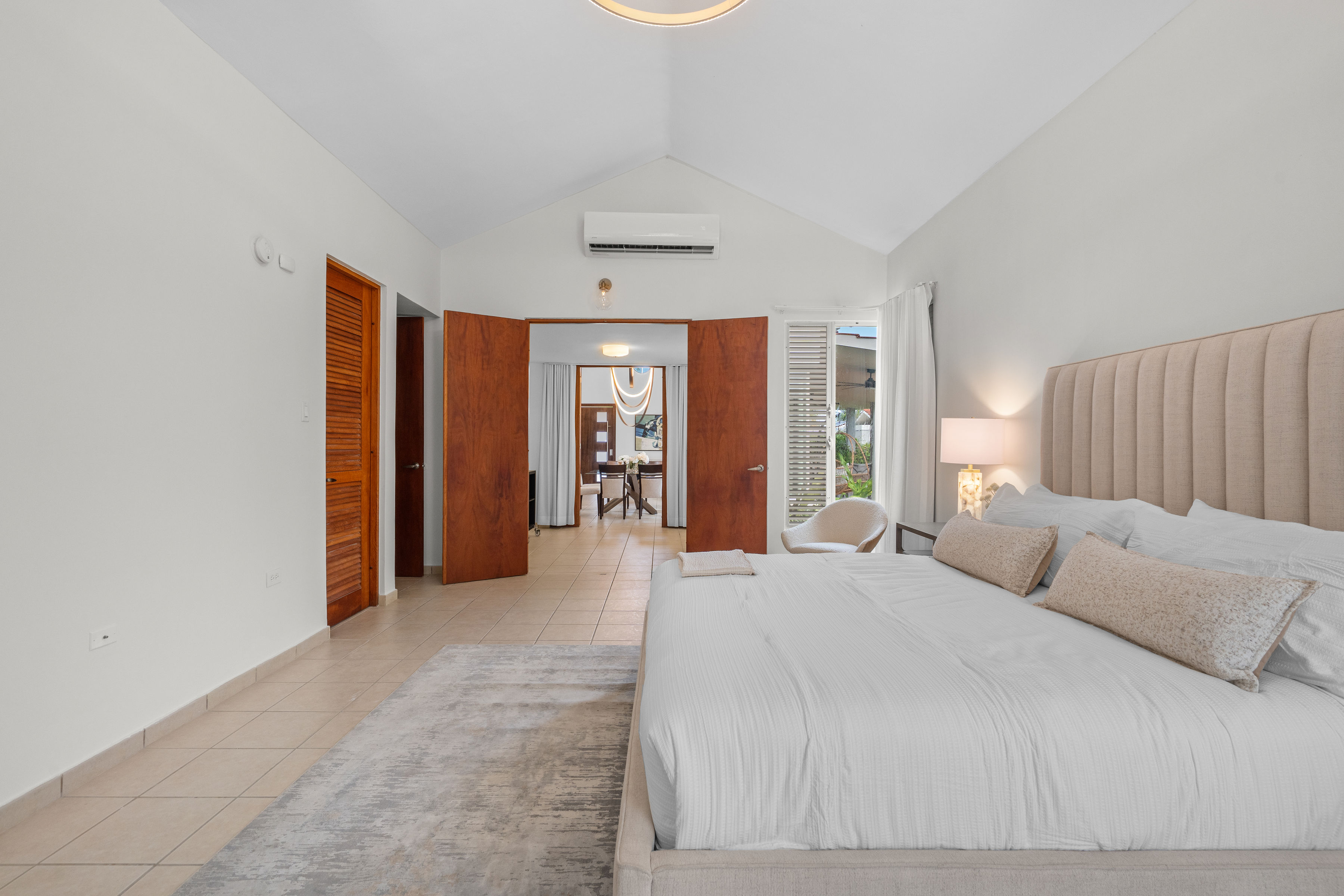 Sabanera Dorado 309 | Primary bedroom with high ceiling and wide double-door entry