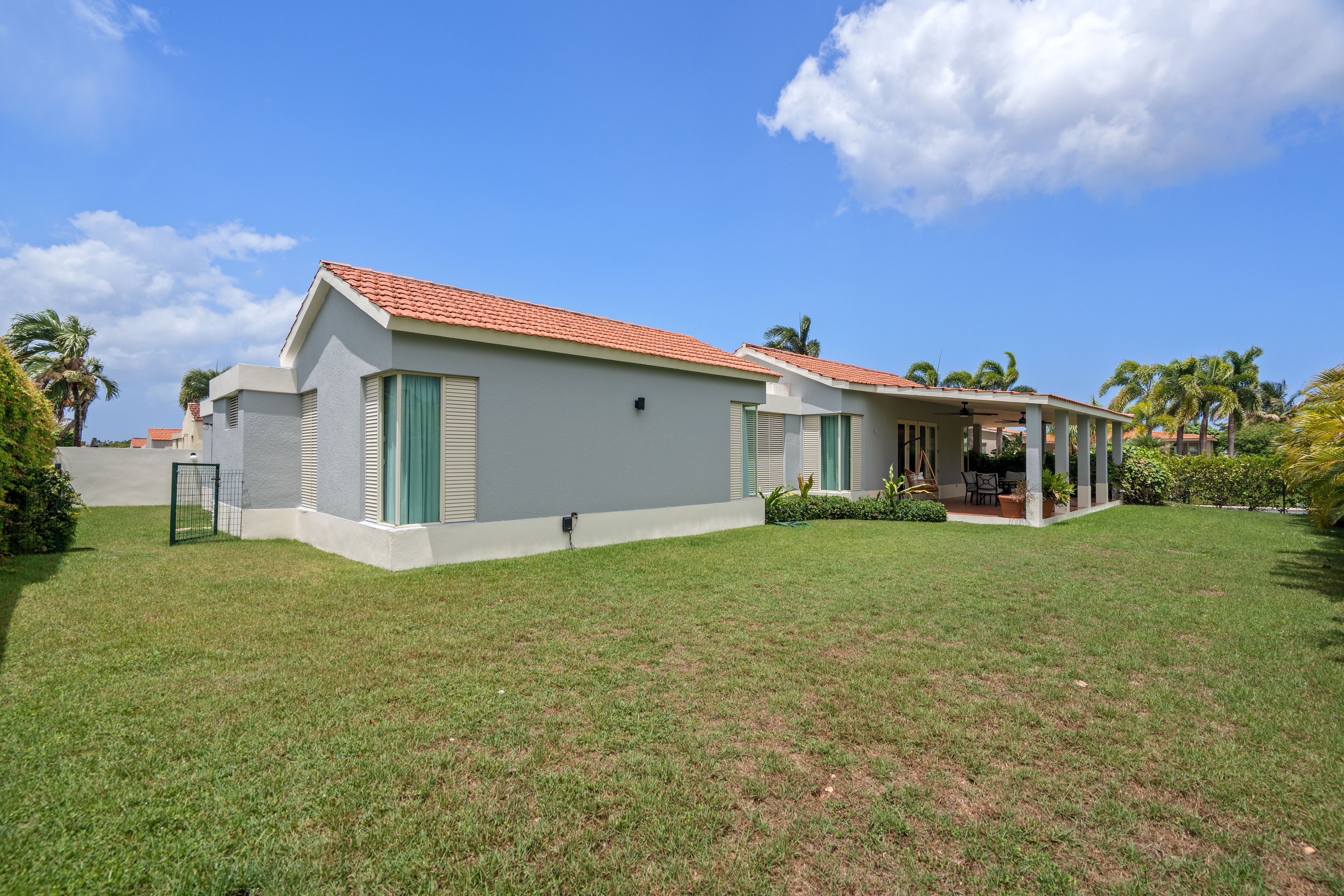 Sabanera Dorado 309 | Landscaped private backyard and exterior of the single-story residence