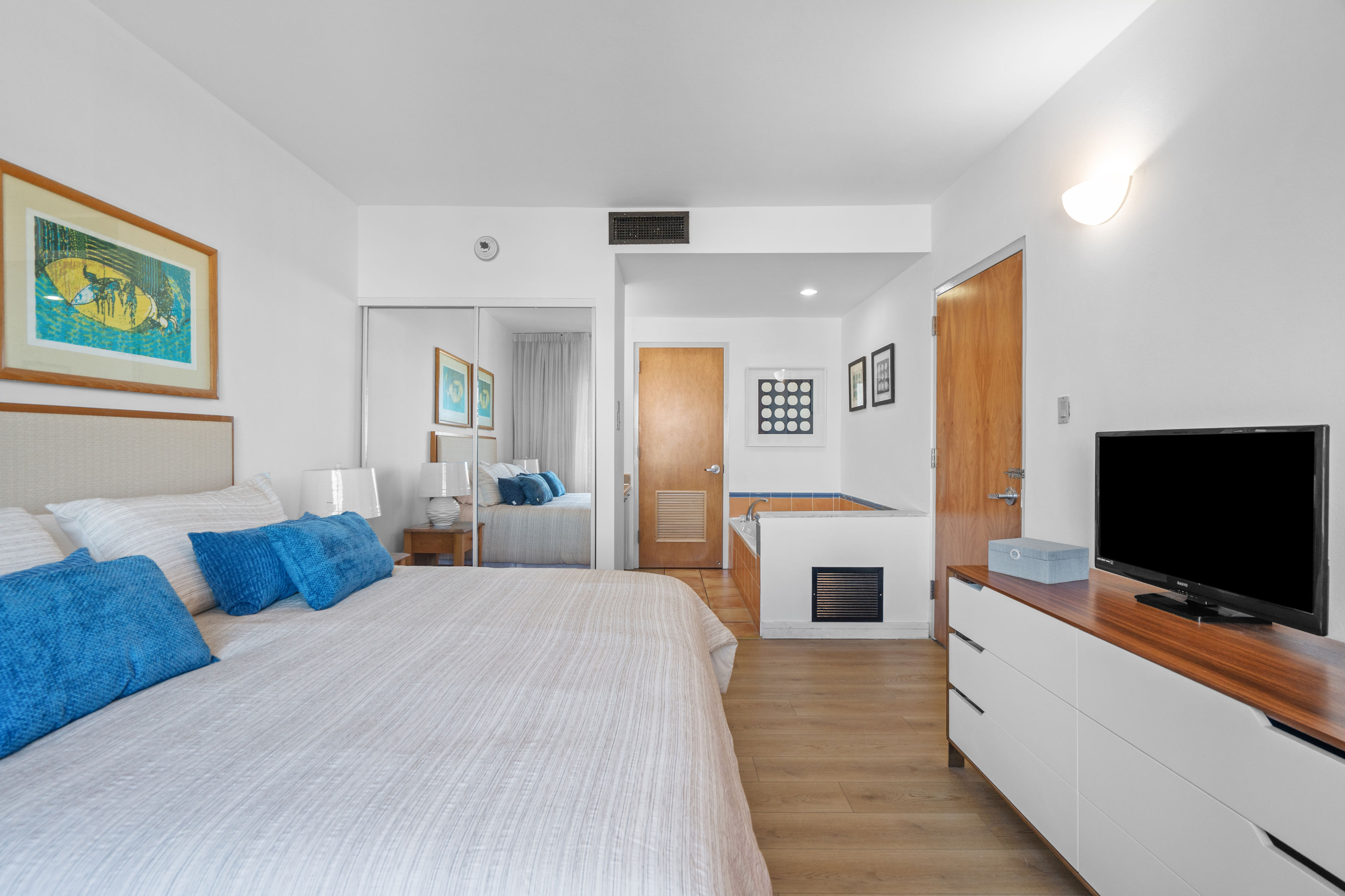Embassy Villas, Dorado del Mar | Furnished primary bedroom with king bed, television, and adjoining bathroom