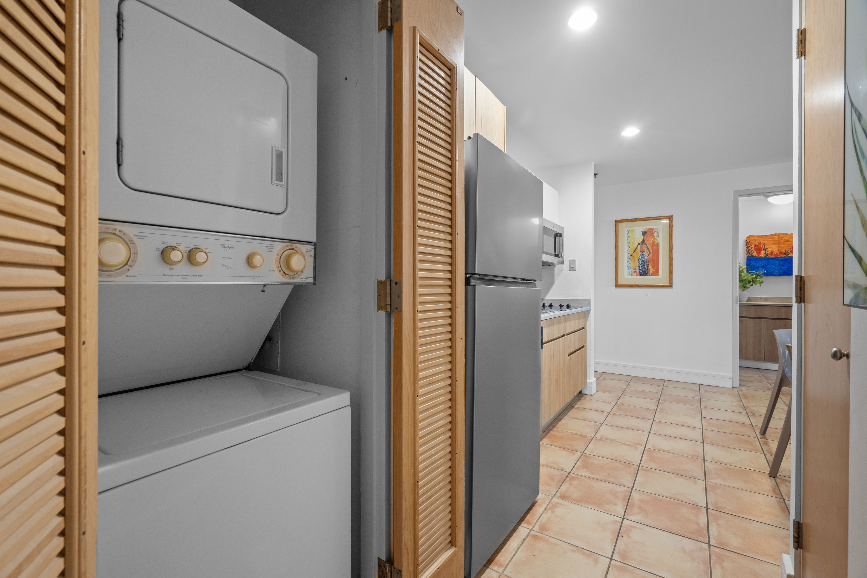 Embassy Villas, Dorado del Mar | Laundry closet with stacked washer and dryer beside the kitchen
