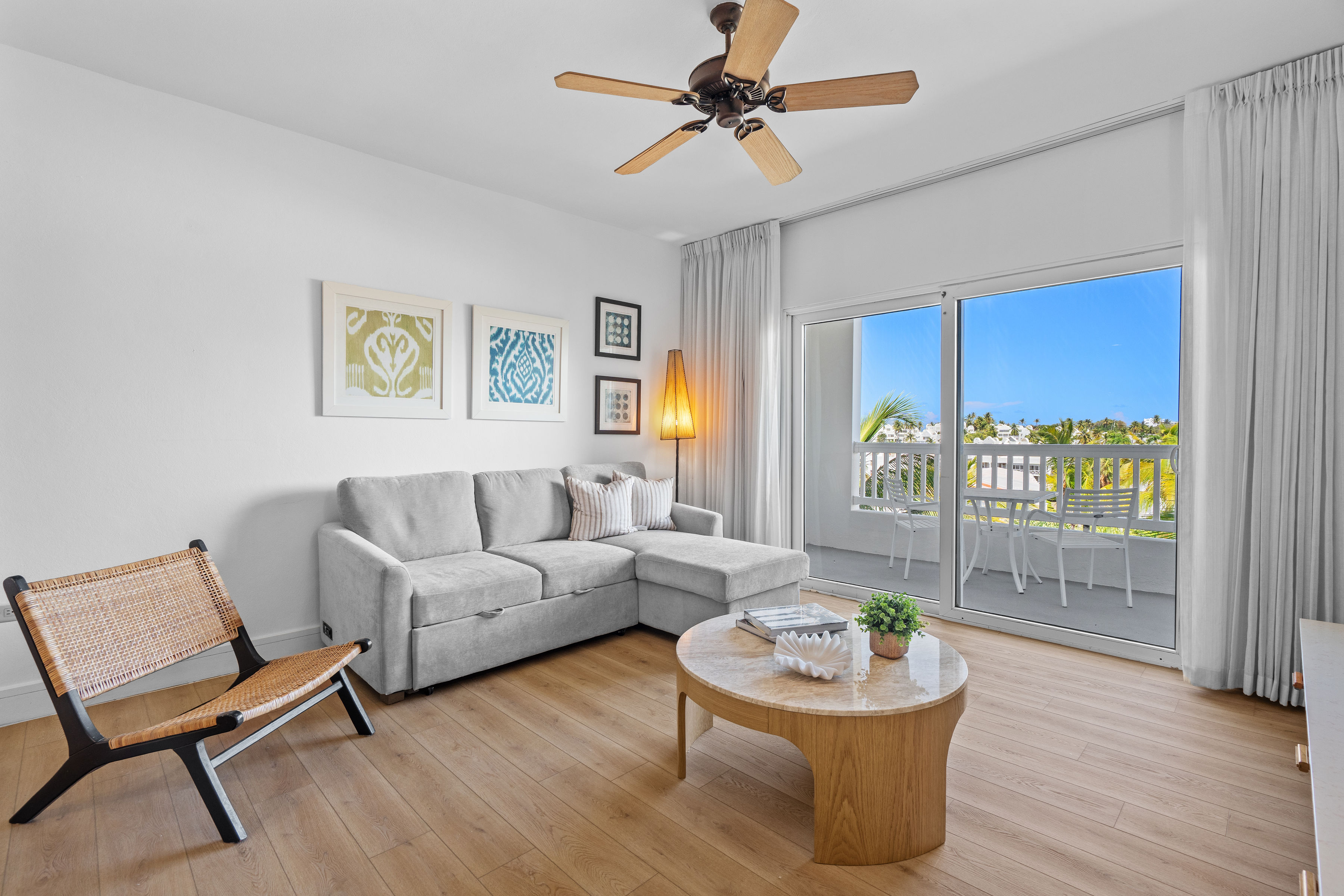 Embassy Villas, Dorado del Mar | Bright living room with contemporary furnishings and views toward the water