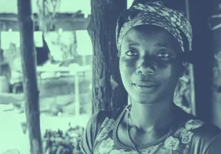 A woman standing in front of a tree.