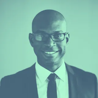 A man in a suit and tie smiling.