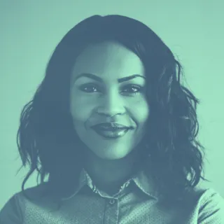 A black and white photo of a woman smiling.