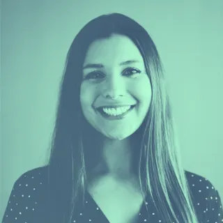 A woman with long hair smiling at the camera.