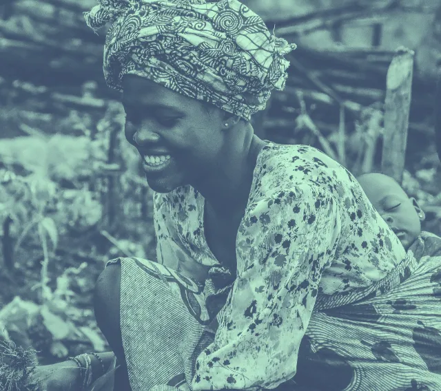 A woman holding a baby in her arms.