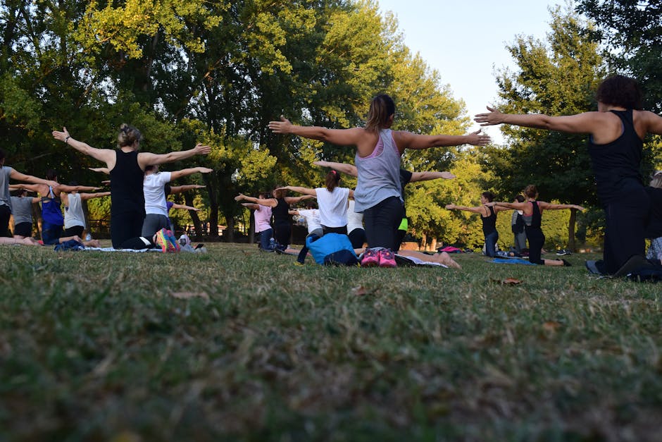yoga in park - holistic stress management techniques