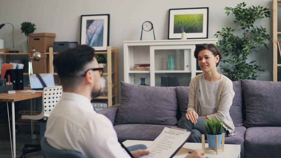 A therapist and client talking in a comfortable office setting - Cognitive behavioral therapy
