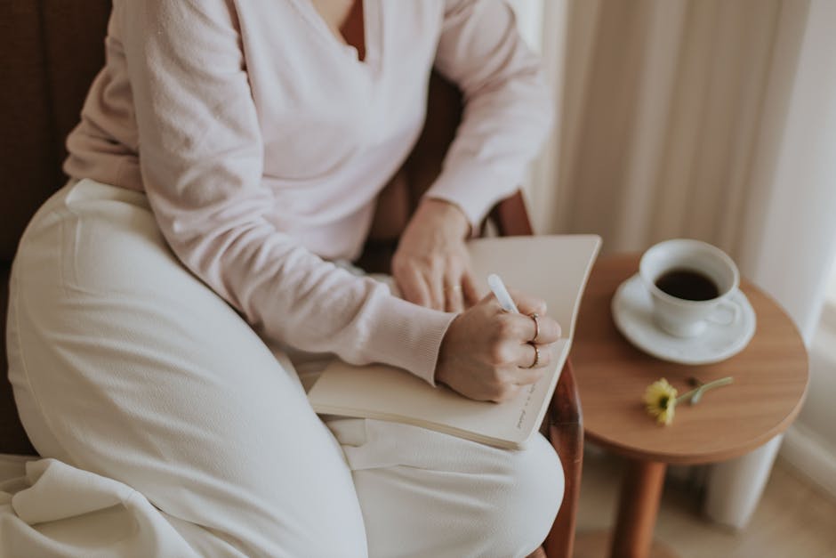 a person journaling thoughtfully - Emotional regulation therapy