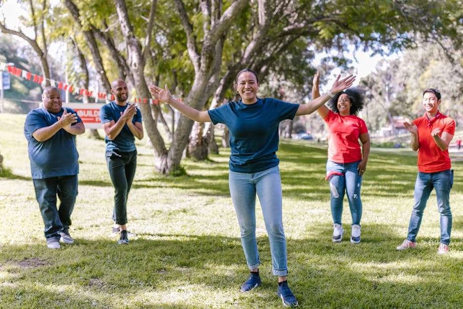 diverse group of employees participating in an outdoor team-building exercise - Corporate wellness workshops