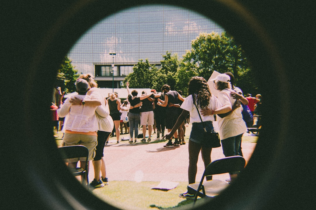 group standing in a circle, showing connection and support - fun mental health group therapy activities for adults