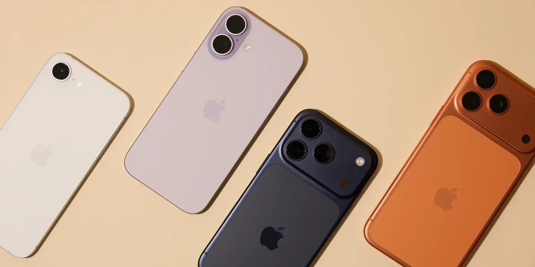 Flat lay of the iPhone 17 and iPhone Air series in new color options including ivory white, pastel lavender, matte black, and burnt orange