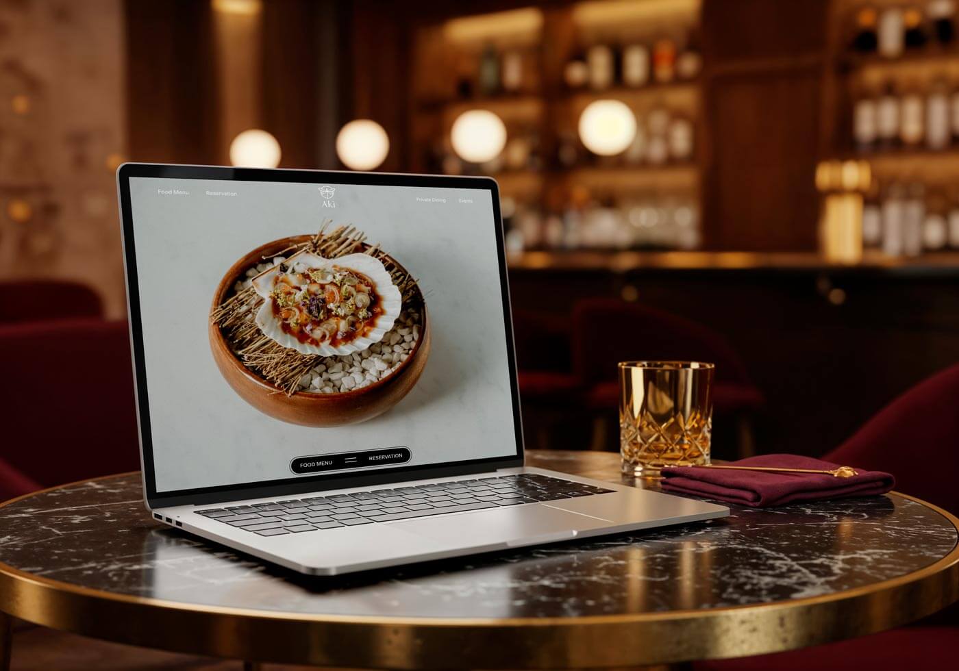 laptop in a cosy restaurant showing the AKI website homepage