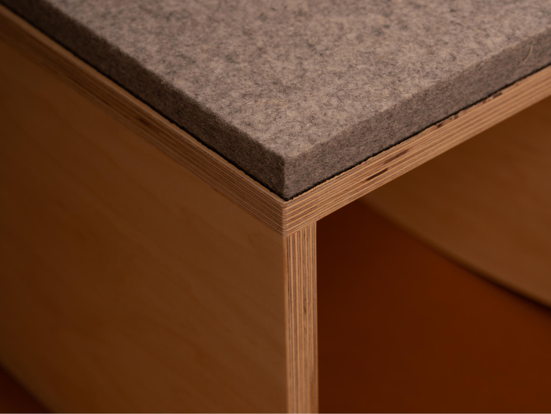 A detail of the mmoa rocker featuring wood and felt construction.