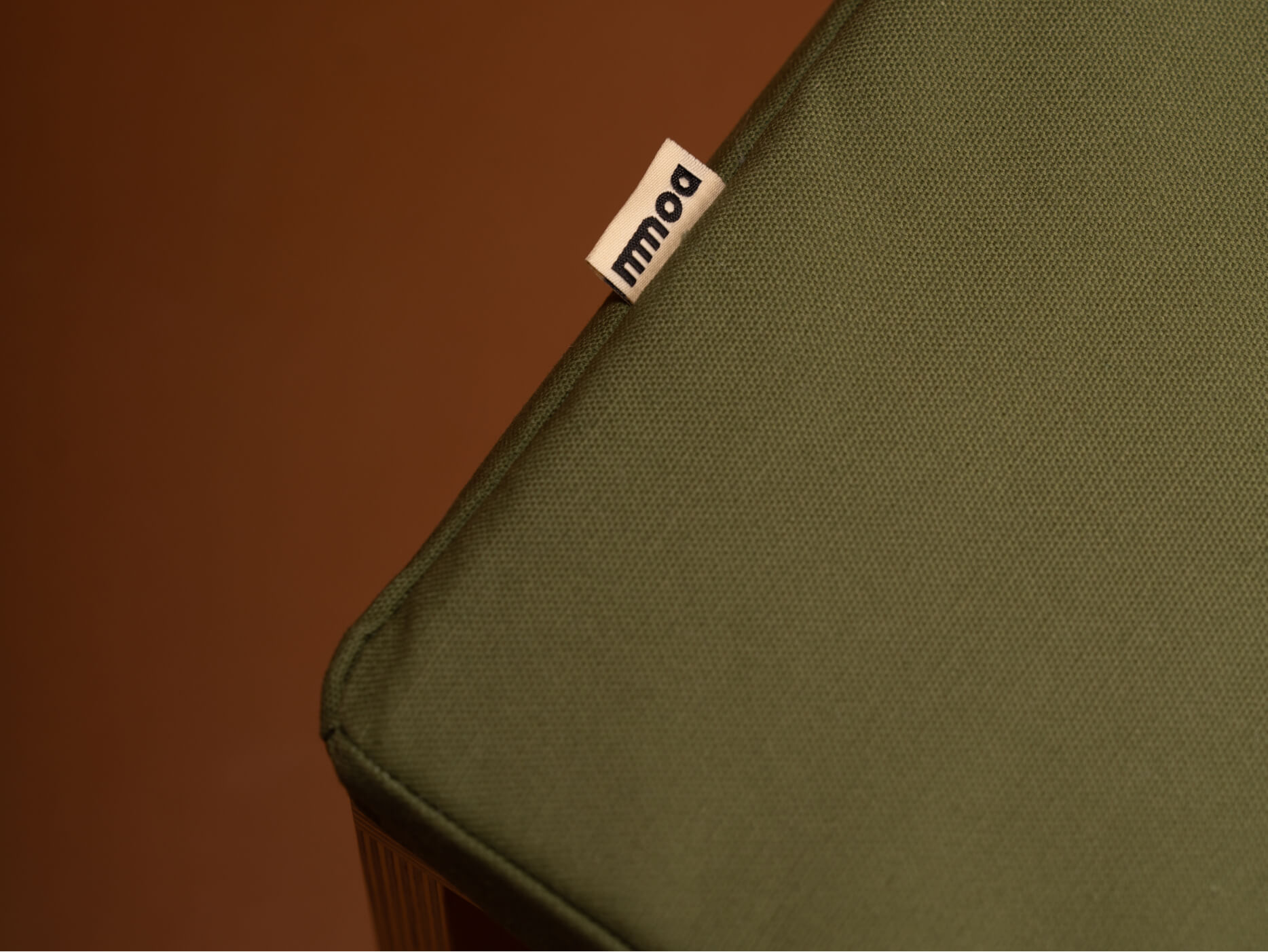 A detail of the mmoa rocker cushion featuring the logo.
