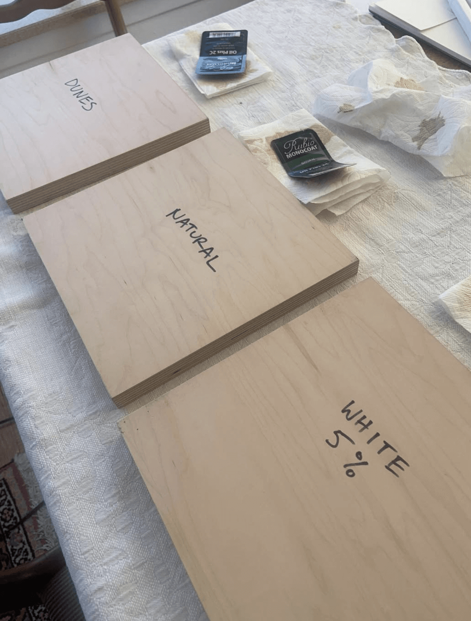 Three wood finish samples arranged on a table.