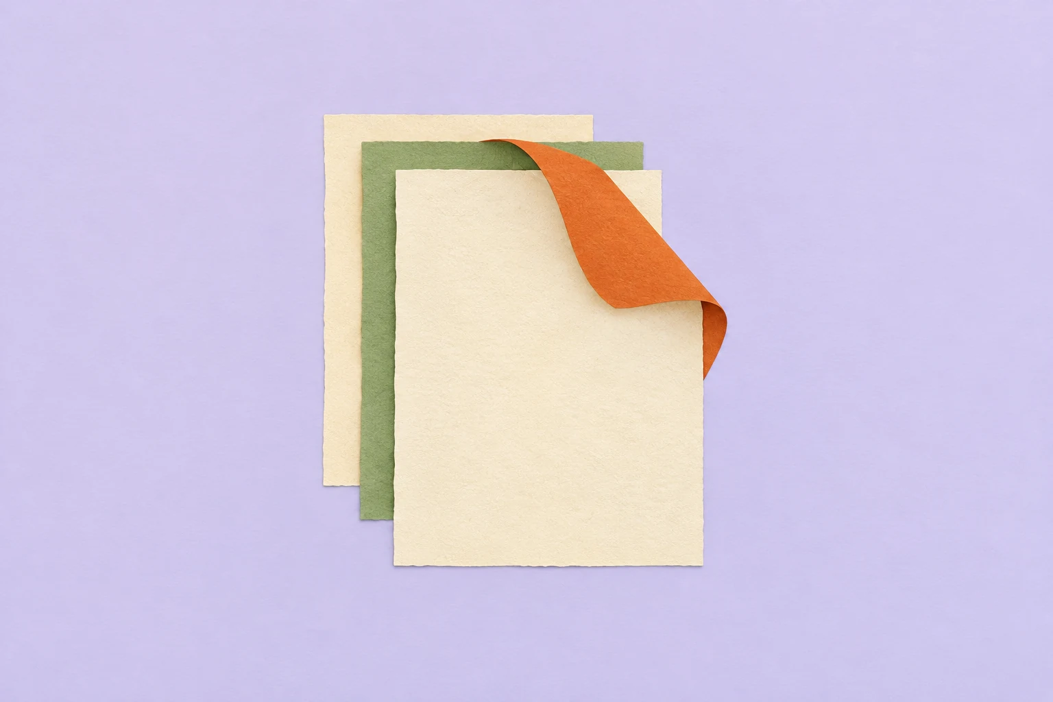 Layered cream and green paper sheets with an orange ribbon folding back over them on a lavender background.