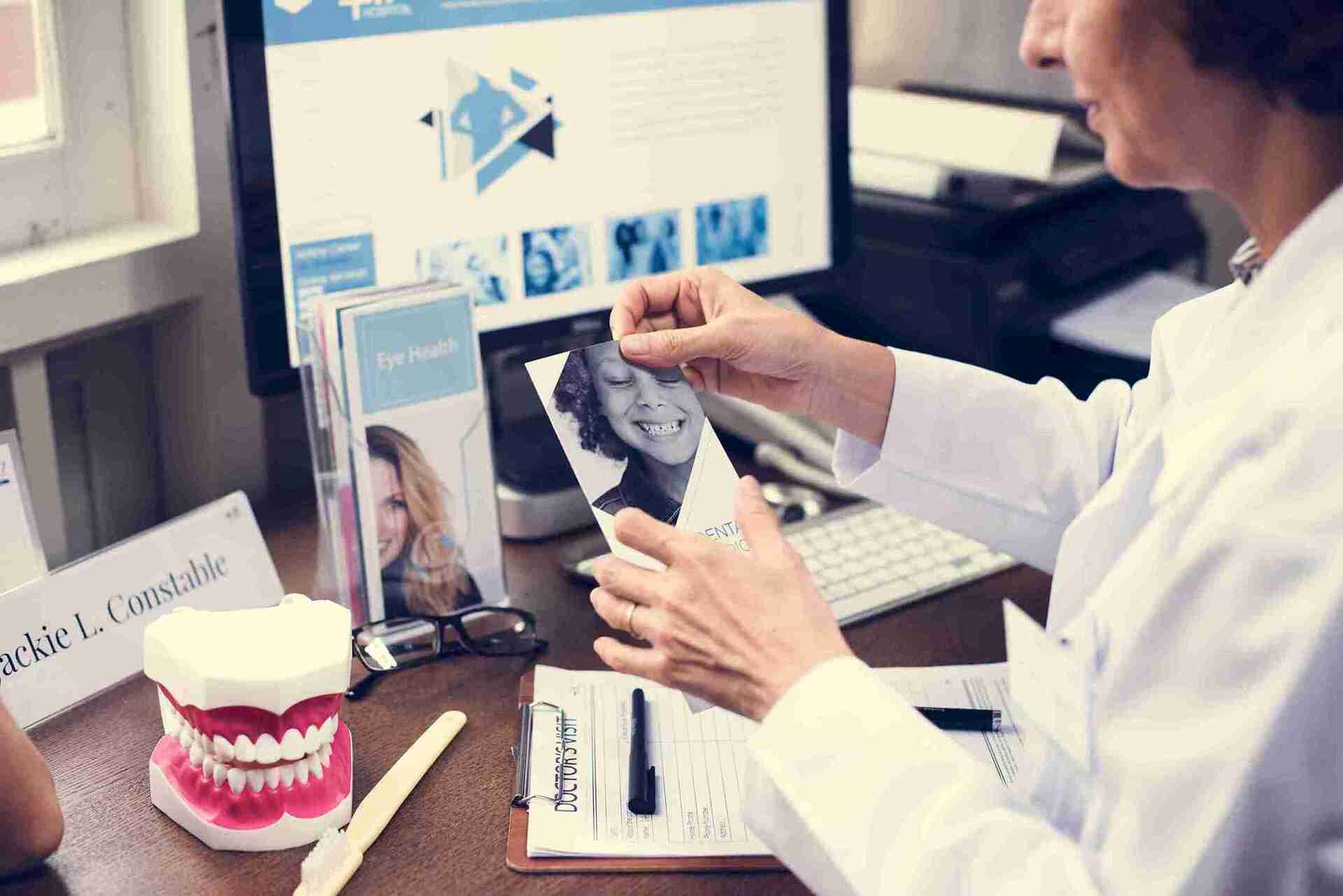 Dentist reviewing dental insurance coordination of benefits (COB) information and claim processing