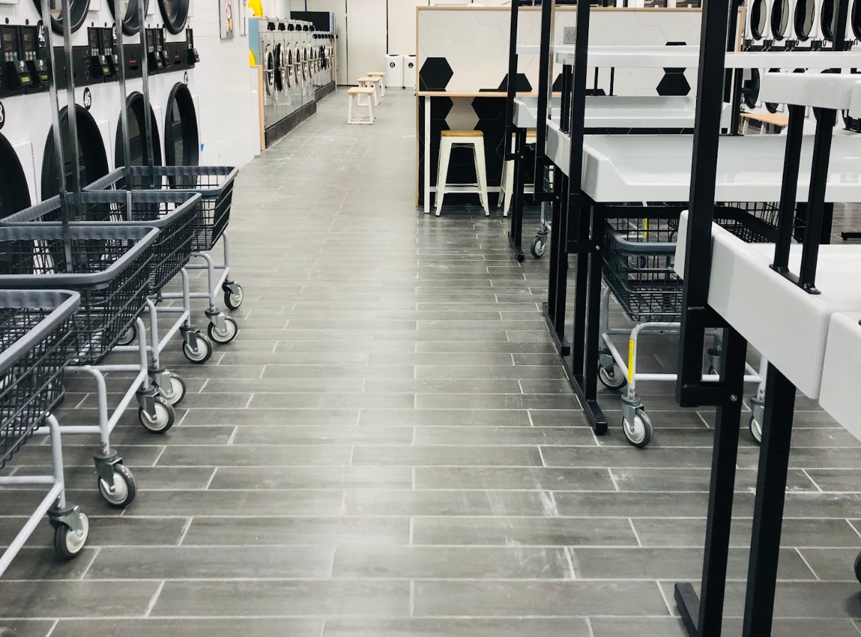 Laundry carts and folding area at LaundryBee Kew Garden Hills