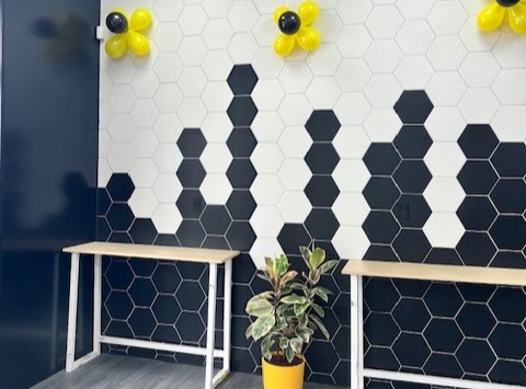 Seating area with hexagon tile wall at LaundryBee Canarsie