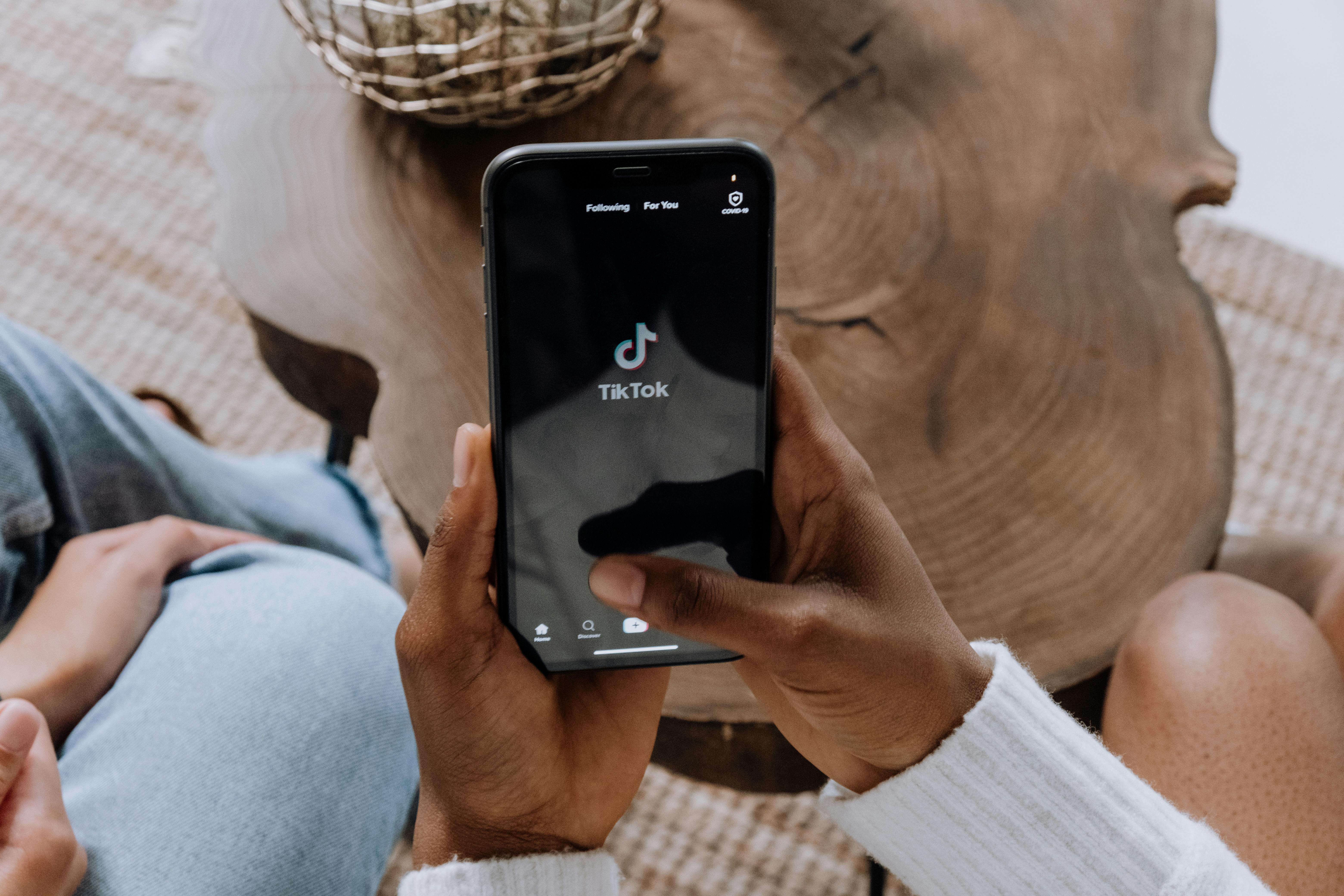 Créatrice de contenu utilisant un smartphone avec éclairage néon pour une vidéo IA TikTok