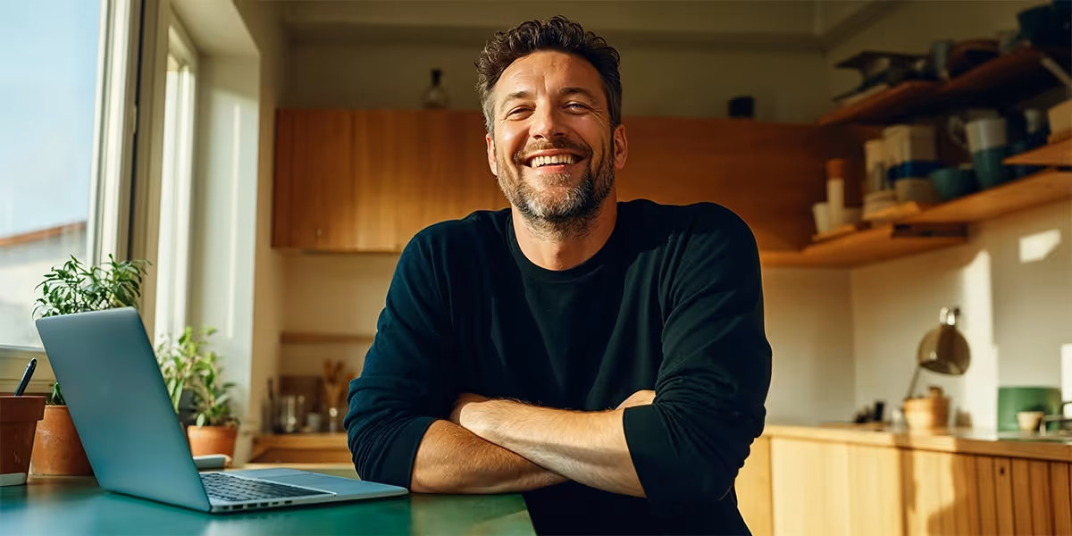 Foto mostra um homem segurando um celular sobre as pernas cruzadas. A tela mostra uma conversa no WhatsApp em que uma pessoa envia um link de pagamento para a outra. A imagem leva o selo da Mastercard de melhor taxa de aprovação