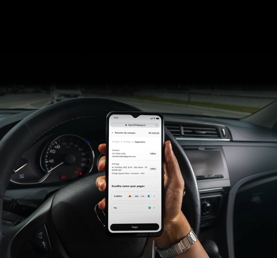Person holding phone in car showing online payment screen with credit and Pix options.