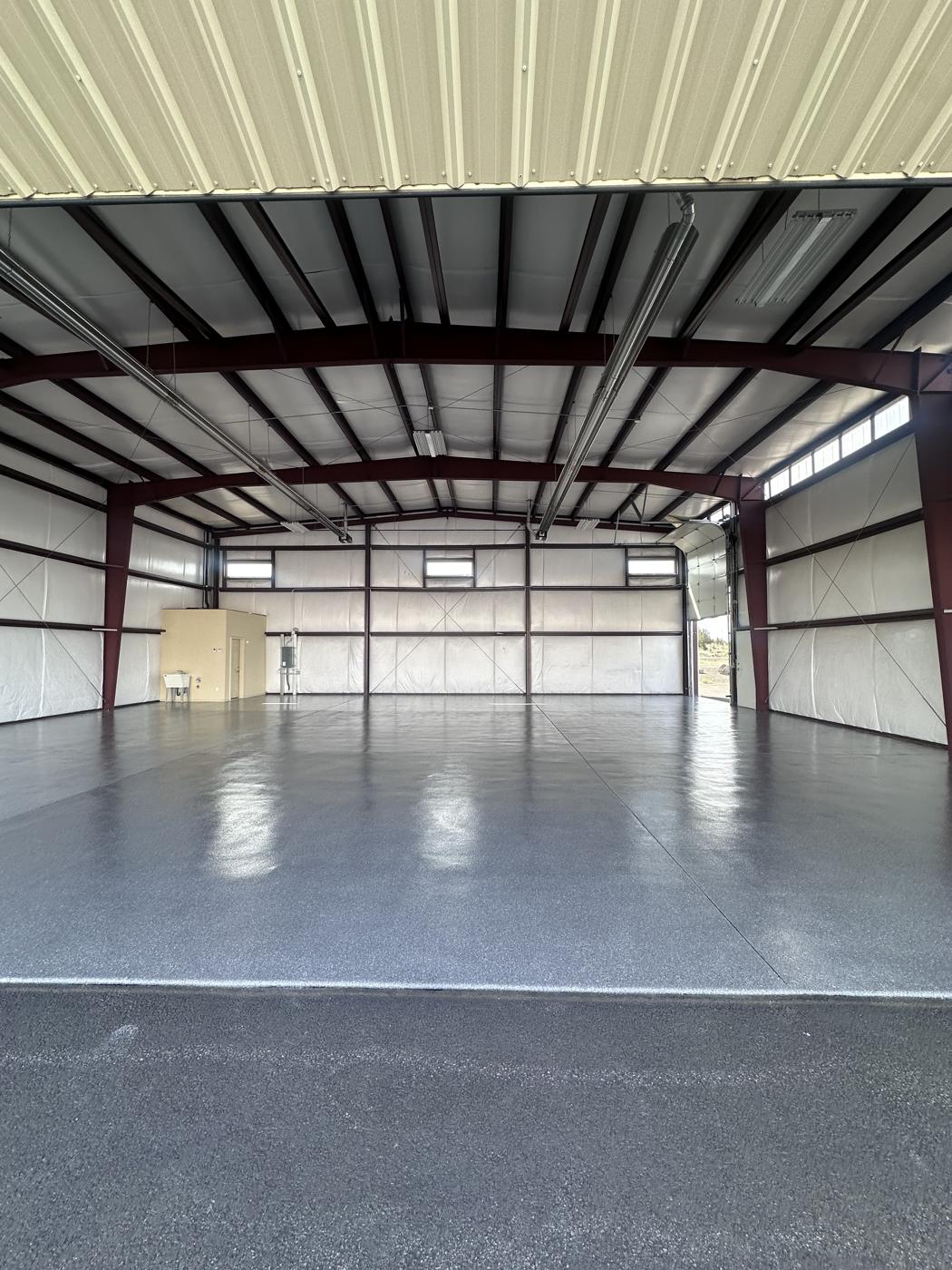Turquoise flake floor coating in a 3,119 square foot airplane hangar in Prineville