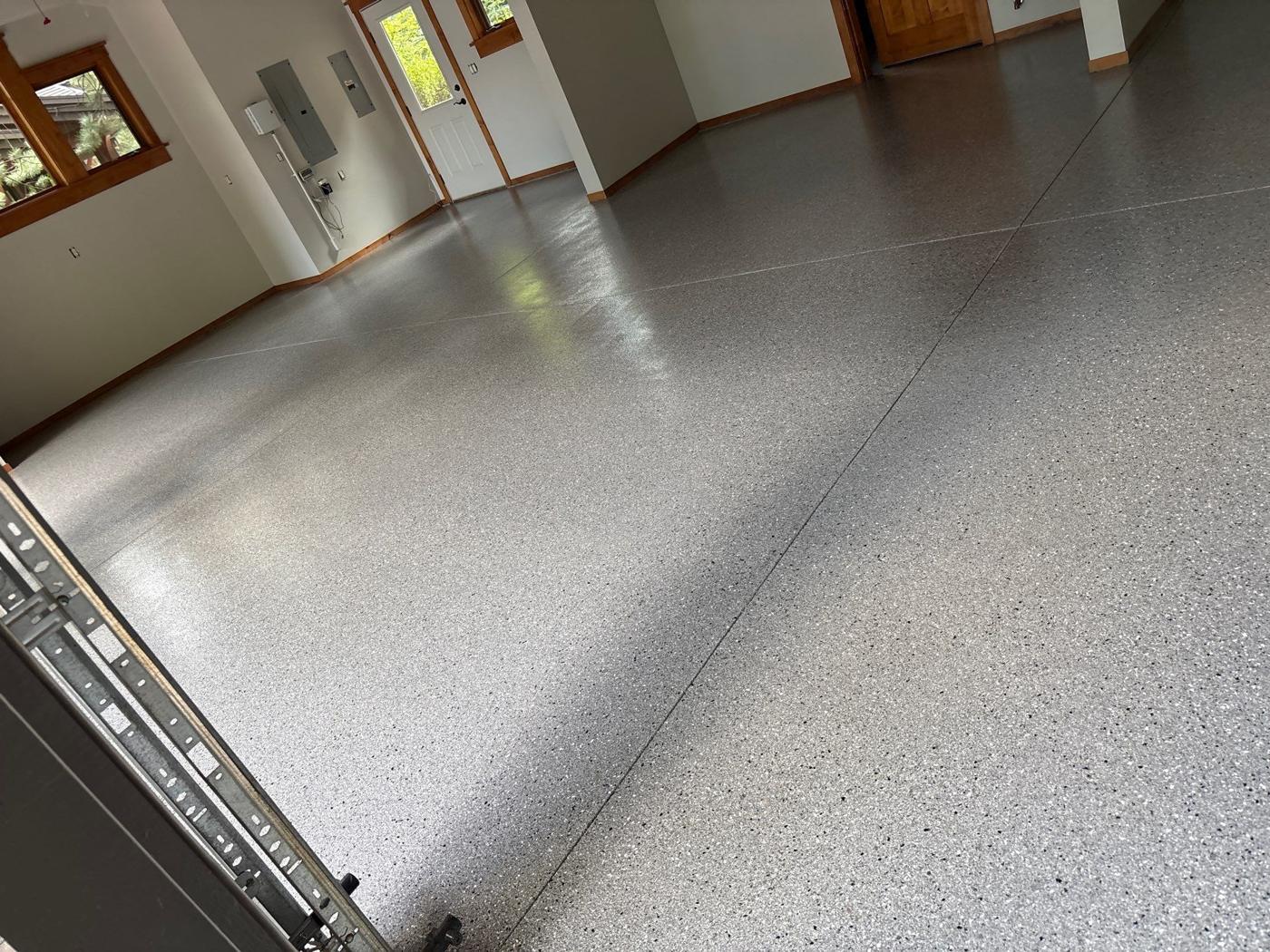 Gray flake polyurea floor coating in a finished garage