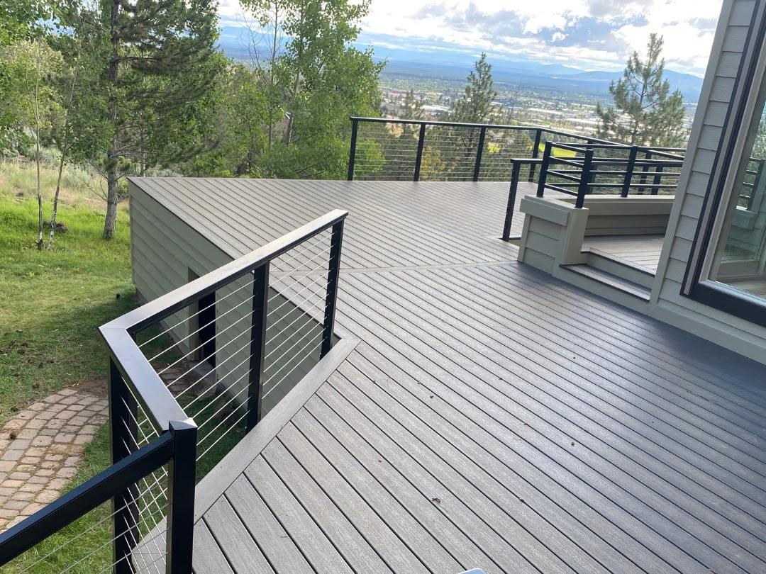 Composite deck with black cable railing overlooking Central Oregon