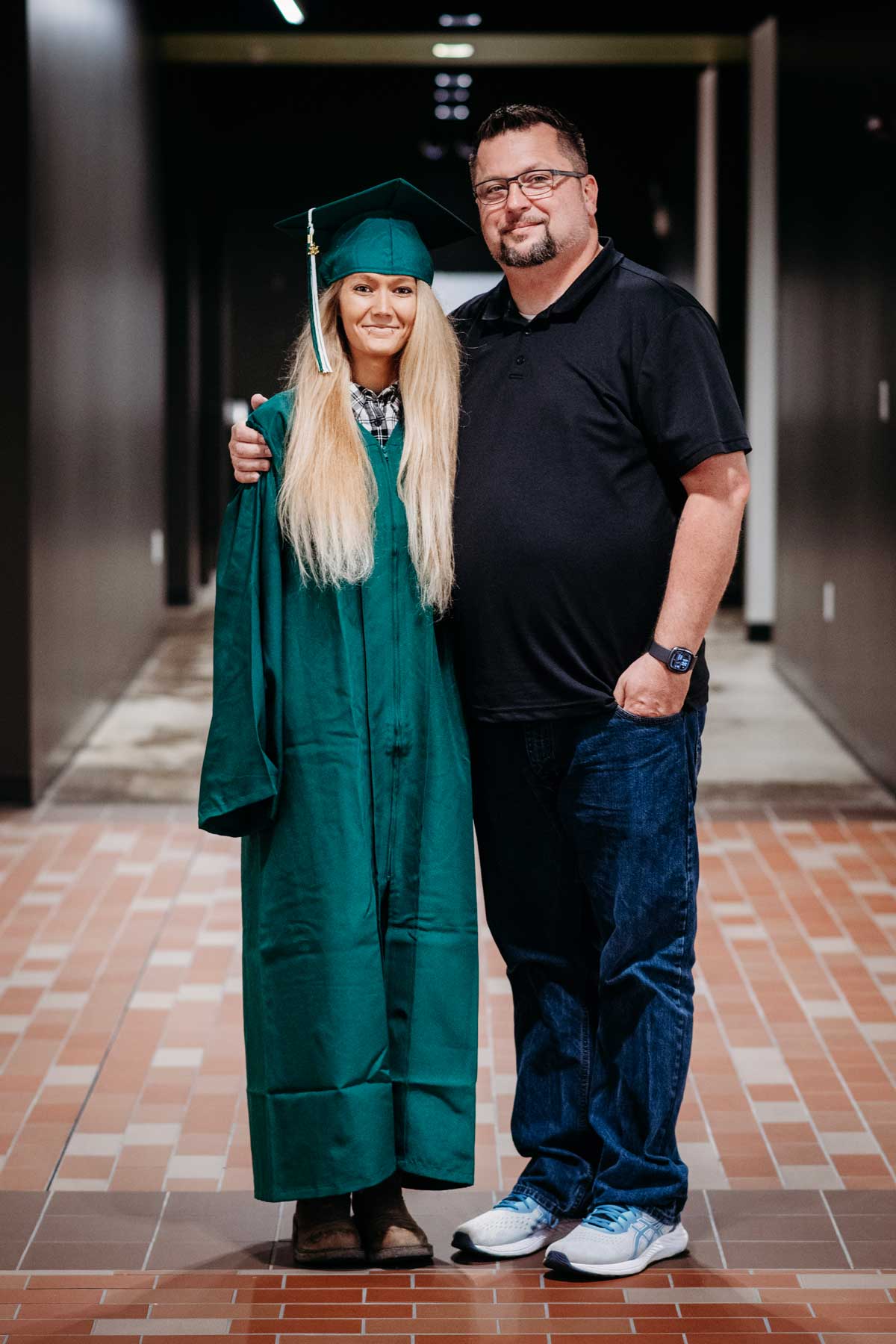 A graduate and another person posing for a picture