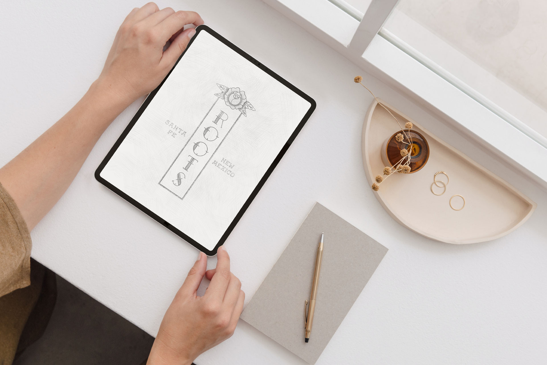 A person diligently writing in a notebook with a pen, emphasizing creativity and organization in their work.