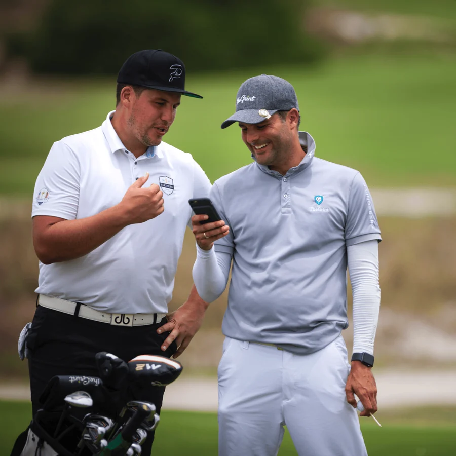 TheGrint founder and CEO Jose Torbay on the course with a fellow golfer