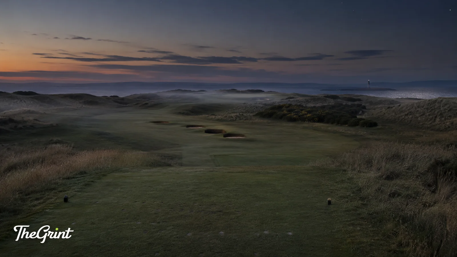 Links golf fairway at dawn between dunes