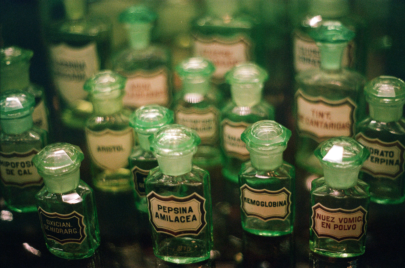 antique green pharmacy bottles with labels in portuguese. from instituto ricardo brenand