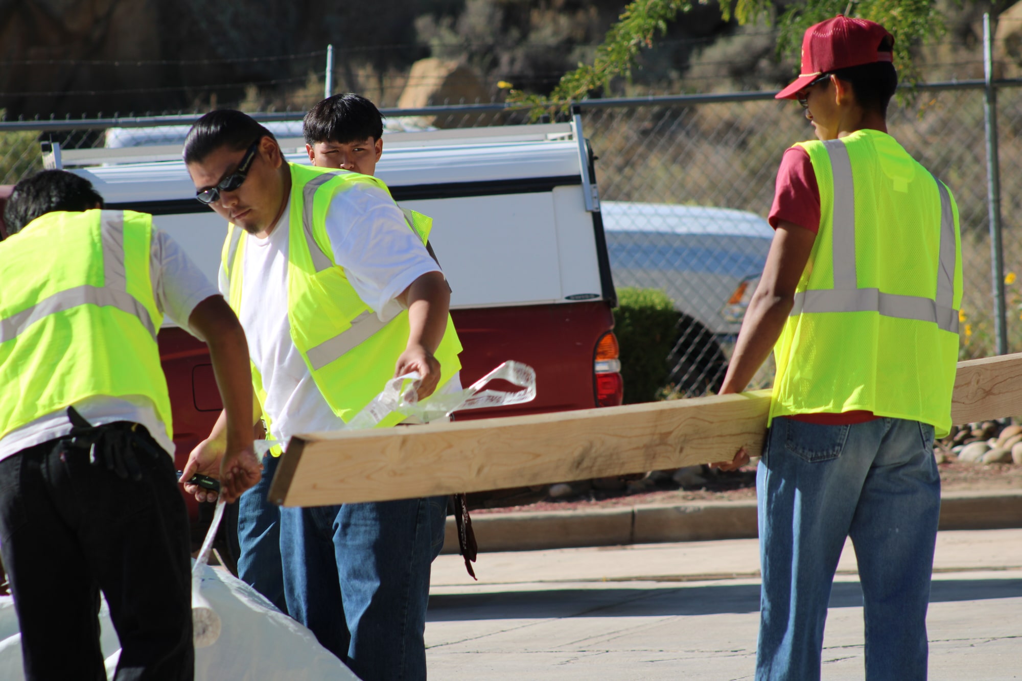 Image of students cutting wood with a saw.