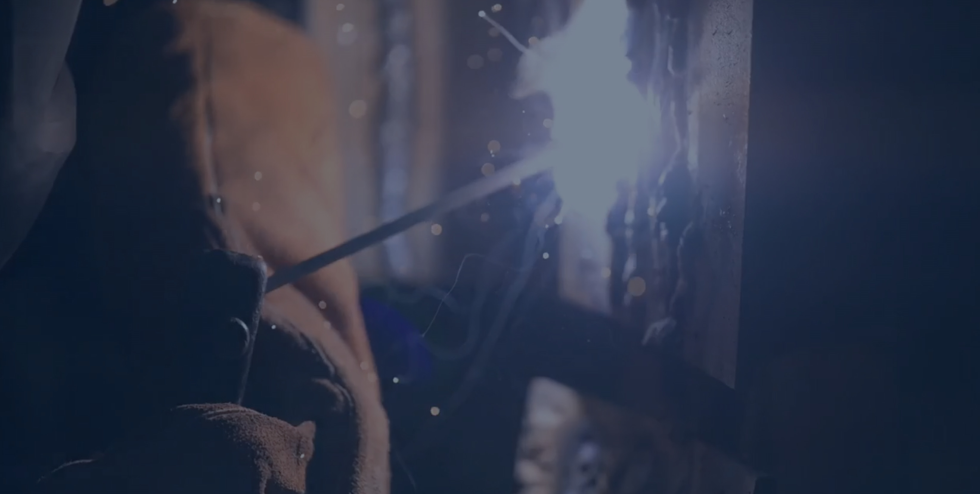 Image of students cutting wood with a saw.