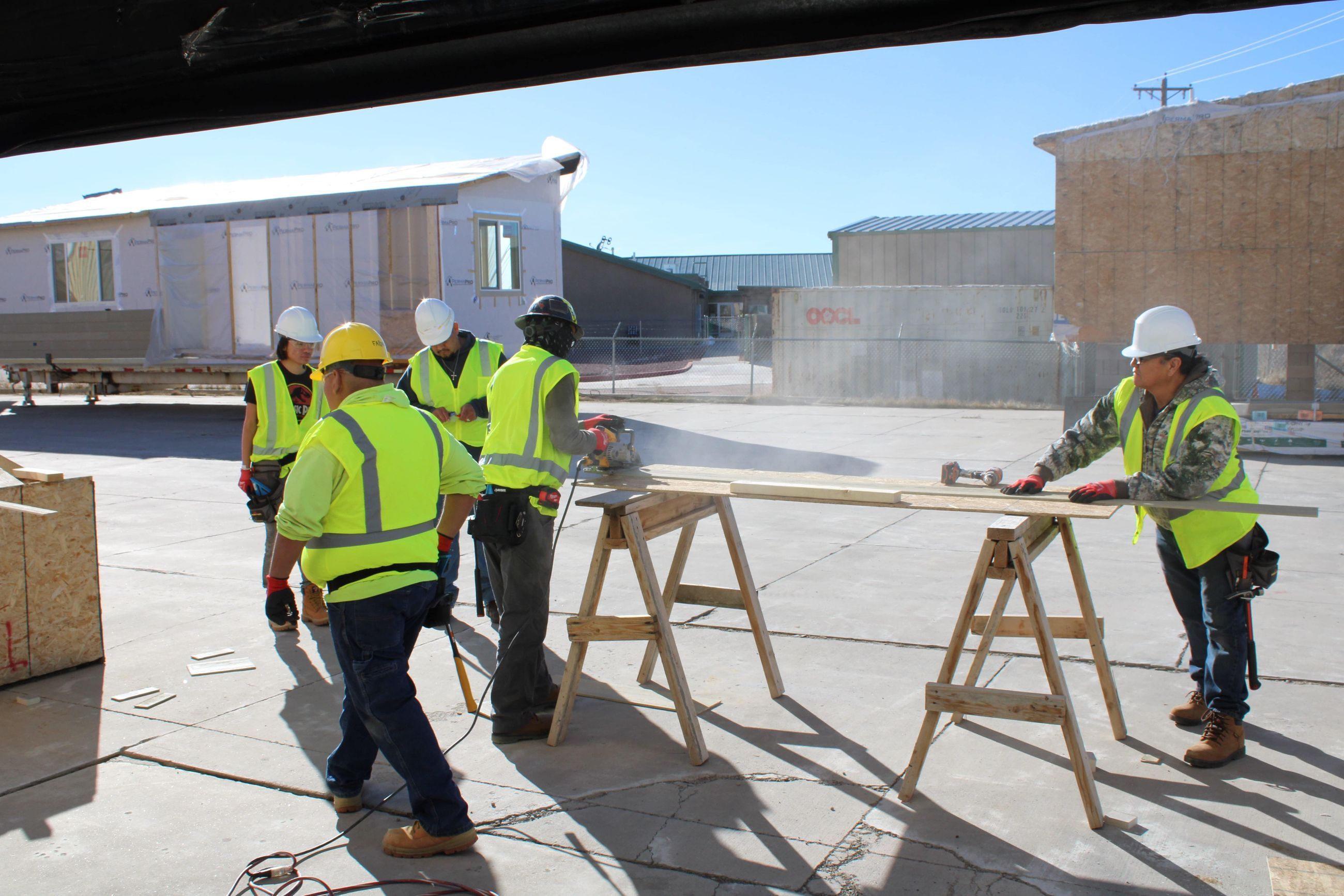 Image of students cutting wood with a saw.