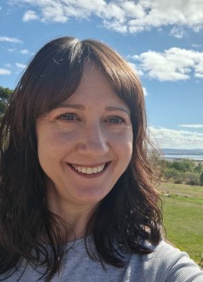 A Caucasian female with brown hair and blue eyes. 