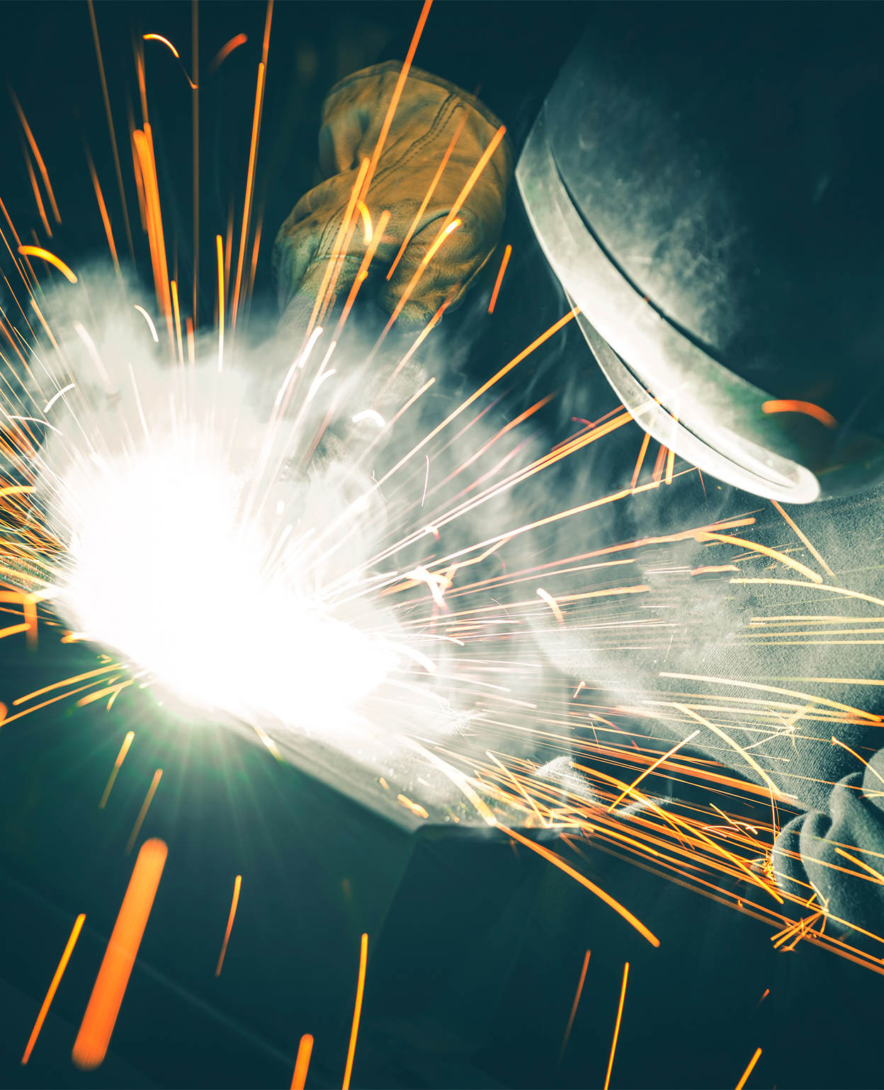Sparks flying as steel is welded in the Quality Custom Iron Works shop