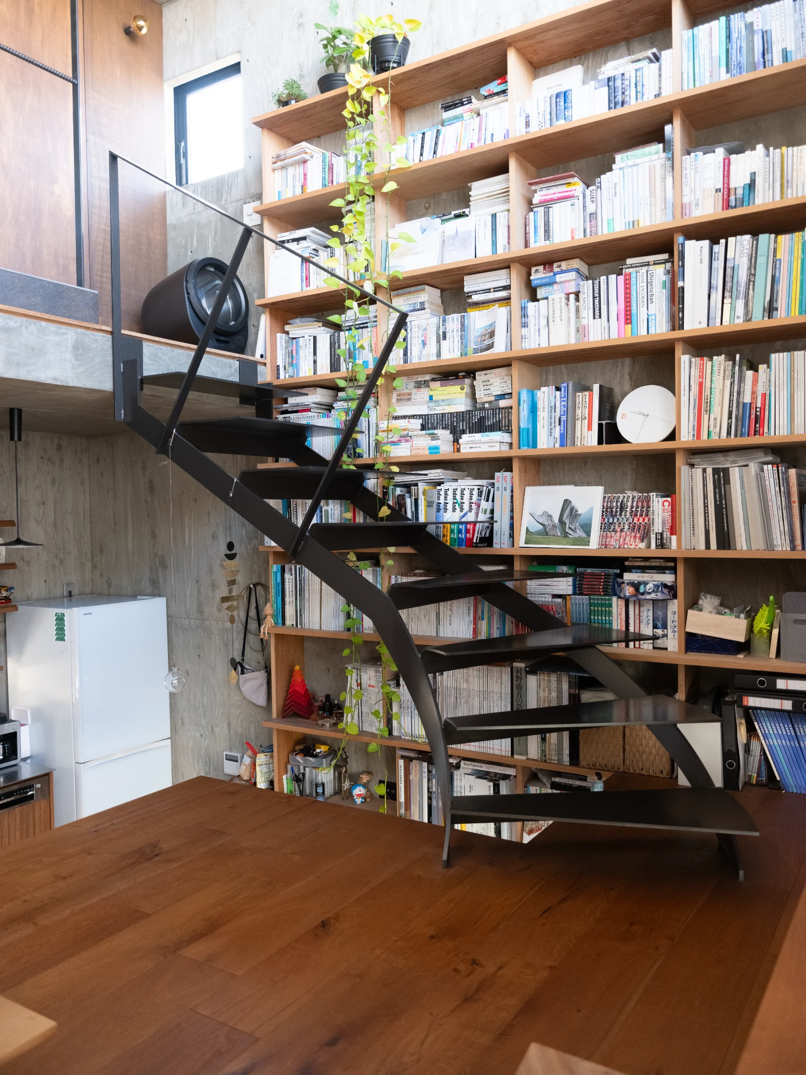 The curved staircase leads the bathroom – the only 'walled' room in the home. Its glass exterior can be made private with curtain.