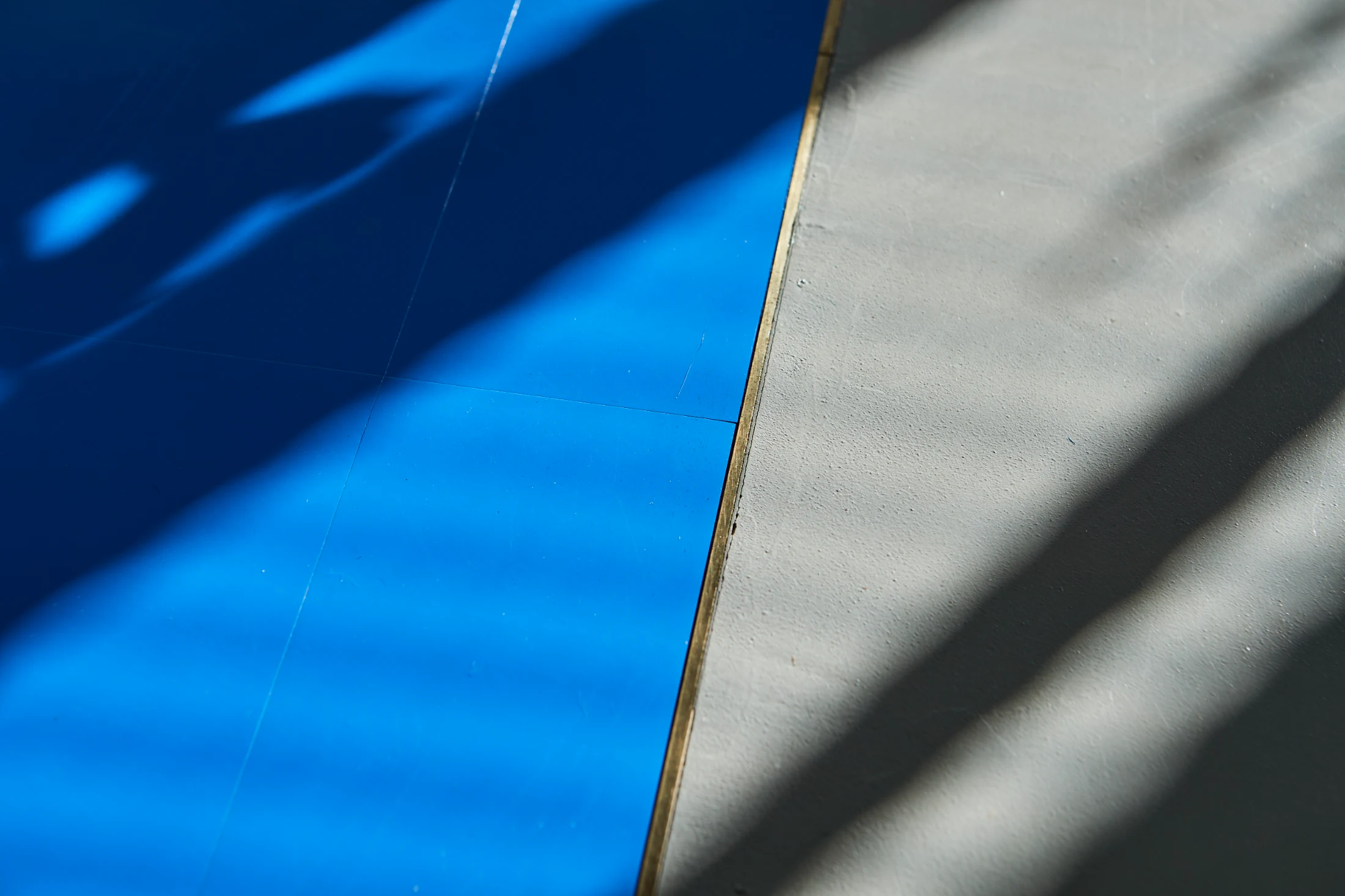 The contrasting floor finishes are separated by a thin brass strip.