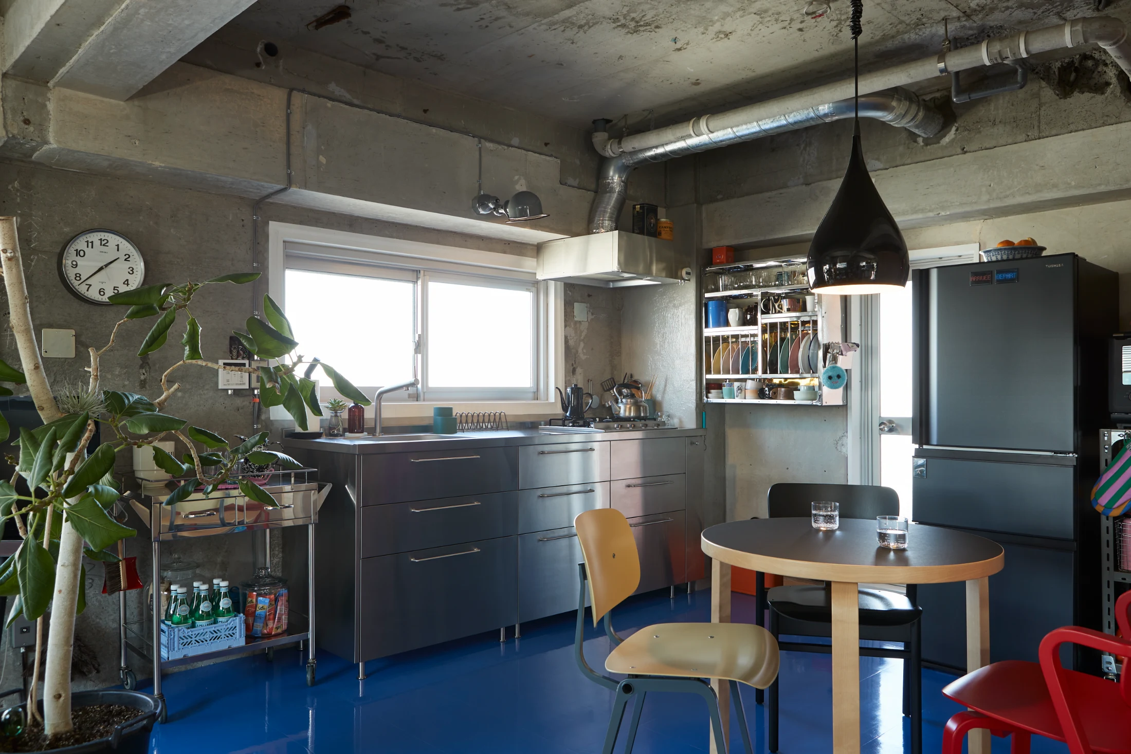 David and Koichi's kitchen features customised IKEA METOD units along with a wall mounted shelving unit from HAY.