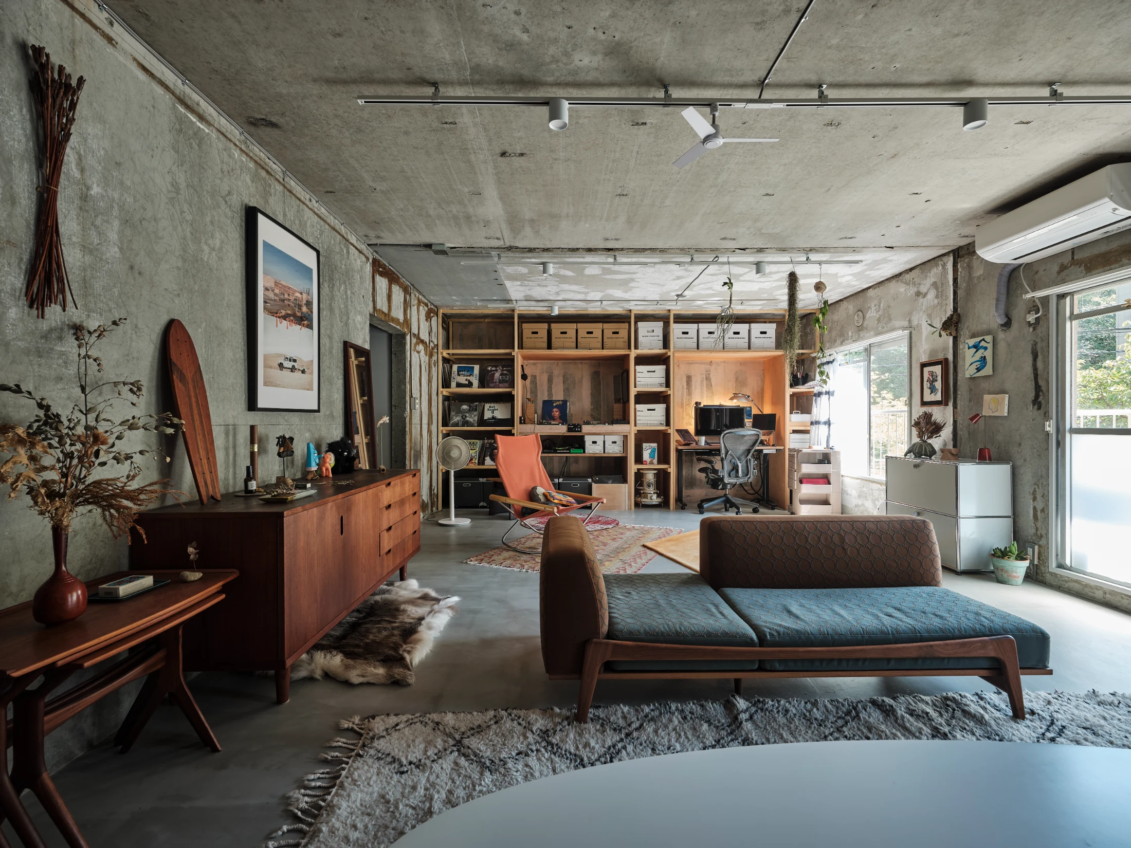 During the renovation of Apartment in Kamakura designed by Roovice as part of its Kariage project, all existing wall, ceiling and floor finishes were stripped away, revealing the apartment's raw structure and the remnants of its past.